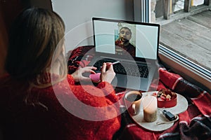 Woman using online dating app on laptop. Valentines Day During The Coronavirus Outbreak. Love at distance, loneliness in