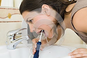 Woman Using Oral Irrigator
