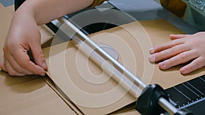 Woman using paper cutter, guillotine, designer working