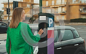 Woman using parking machine