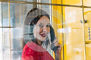 woman using payphone