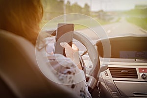 Woman using phone while driving the car