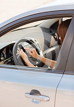 Woman using phone while driving the car