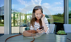 Woman using phone on terrace