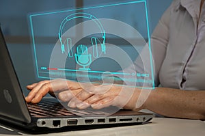 Woman using player and headphones on laptop