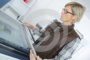 Woman using printer on table