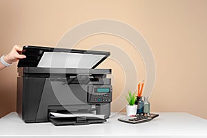 Woman using the printer to scanning and printing document