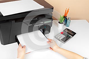 Woman using the printer to scanning and printing document