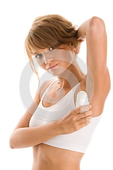 Woman using roll on deodorant