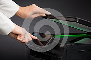 Woman using scanner multifunction device.