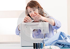 Woman using sewing machine