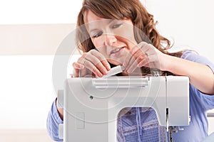 Woman using sewing machine