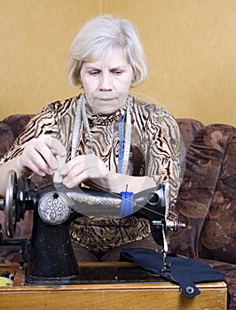 Woman using sewing machine at home