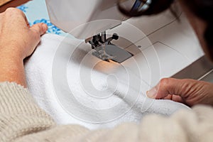 Woman Using Sewing Machine, woman tailor busy stitching