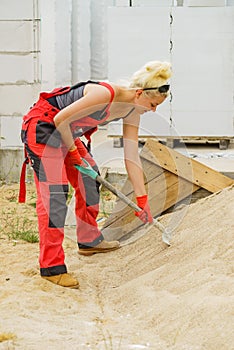 Woman using shovel on constriction site