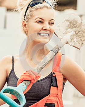 Woman using shovel on constriction site