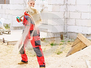 Woman using shovel on constriction site