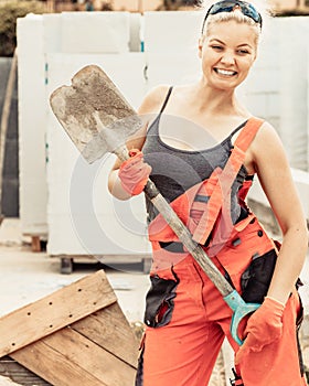 Woman using shovel on constriction site