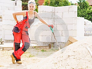 Woman using shovel on constriction site