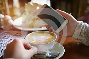 Woman using smart phone in the cafe