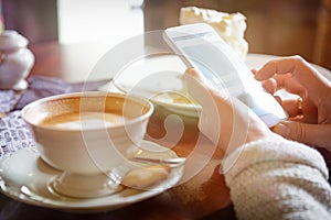 Woman using smart phone in the cafe