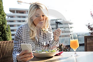 Woman using smart phone in cafe