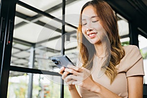 woman using smart phone for shopping online at cafe coffee shop in the morning