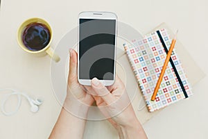 Woman using smart phone on the table