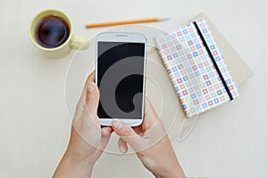 Woman using smart phone on the table