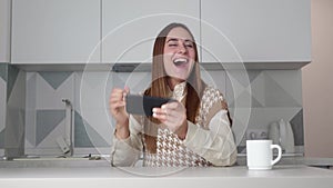 woman using Smart phone Winning Concept celebrating success.