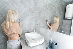 Woman using smart wall home control system