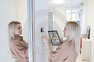 Woman using smart wall home control system