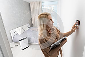 Woman using smart wall home control system