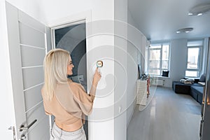 Woman using smart wall home control system