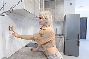 Woman using smart wall home control system