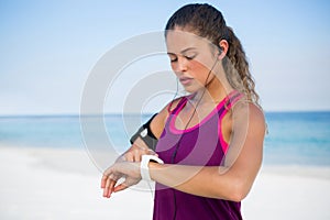 Woman using smart watch at beach