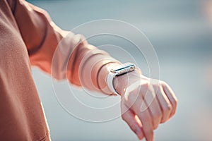 Woman using smart watches with checking pulse via health application.