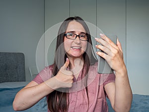 woman using smartphone on the bed