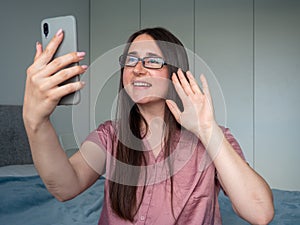 woman using smartphone on the bed