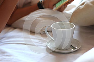 Woman using smartphone on bed