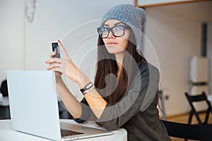 Woman using smartphone in cafe