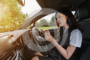 Woman using a smartphone in a car