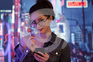 Woman Using a Smartphone in the City at Night