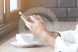 Woman using smartphone in coffee shop