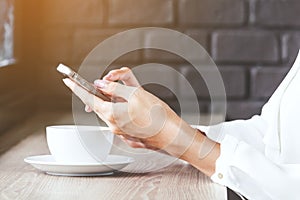 Woman using smartphone in coffee shop