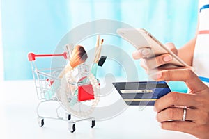 Woman using smartphone and credit card shopping beauty items. Online shopping, e-payment