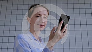 Woman using smartphone, having video chat, interview or consultation