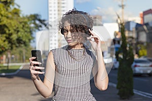 Woman using smartphone and headset for video call