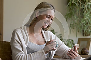 Woman using a smartphone in her home