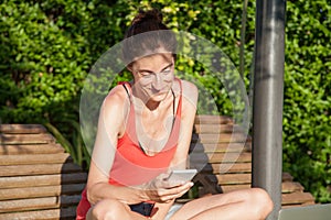 Woman using smartphone on lounge deck chair